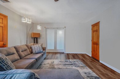 Living room with baseboards, an inviting chandelie