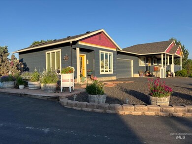 View of front of house with an attached garage and covered porch