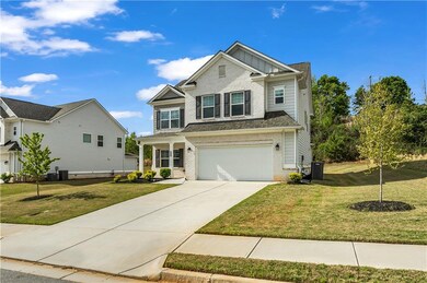 Craftsman house featuring an attached garage, bric