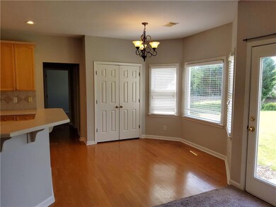 Unfurnished dining area with baseboards, visible vents, a notable chandelier, and light wood-style floors