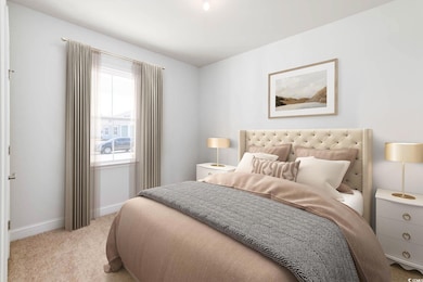 Carpeted bedroom featuring baseboards