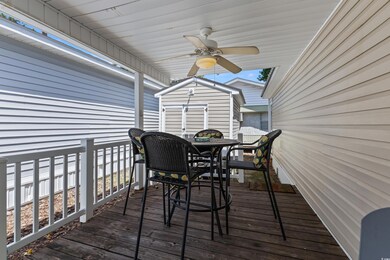 Wooden terrace with ceiling fan and a shed