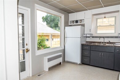 kitchen showing large window overlooking the back