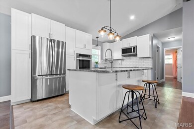 Luxury vinyl tile highlights the kitchen area, which opens to DR and LR