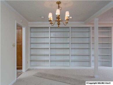 Dining area with chandelier is conveniently located near the kitchen.
