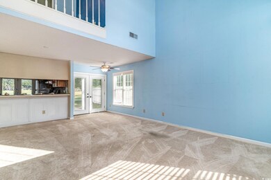 Unfurnished living room featuring ceiling fan, a t