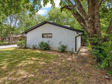 View of side of home with a yard