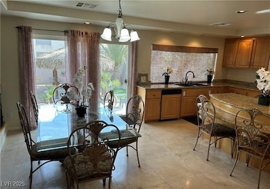 Dining area featuring recessed lighting, a chandel