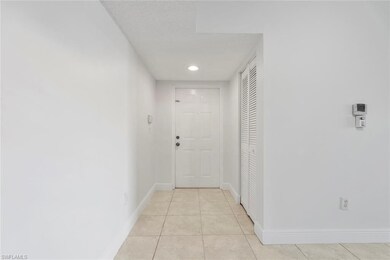 Corridor featuring light tile patterned floors