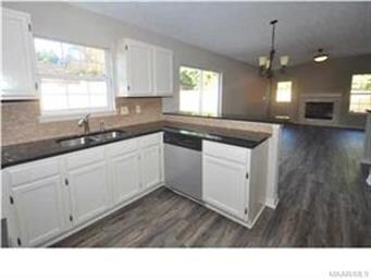 Kitchen features granite counter-tops and stainles