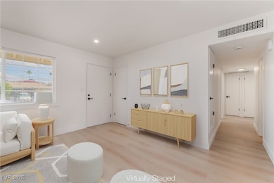 Sitting room featuring wood finished floors and recessed lighting