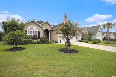 View of front of property with driveway, an attached garage, and a front lawn