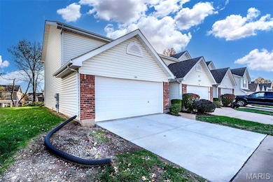 View of front of house with brick siding, concrete driveway, a front lawn, a residential view, and a garage