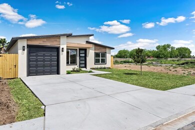 View of front facade with a garage and a front lawn