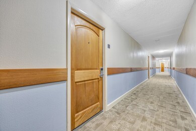 Corridor featuring baseboards and a textured ceili