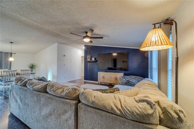 Living room featuring lofted ceiling, a textured c