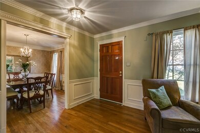 Entry foyer with warm hardwoods, coat closet, dent