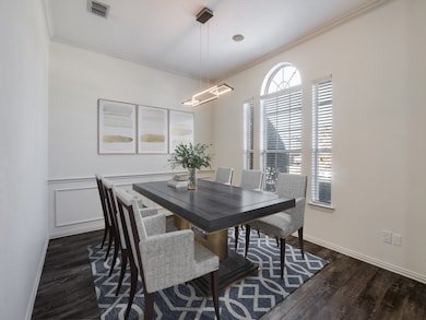 Dining room  virtually staged featuring ornamental molding and luxury vinyl floors