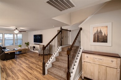 Stairway featuring wood finished floors and ceiling fan