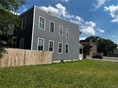 View of side of property with a lawn