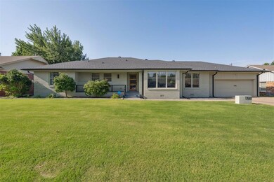 Ranch-style house with brick siding, roof with shingles, an attached garage, and a front yard