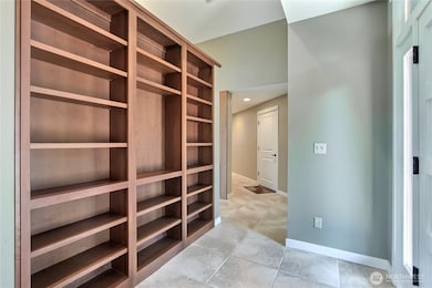 Upon entry, you will find this wall of built-in shelving, you decide how you will greet your guests! Books? Art? So many possibilities.