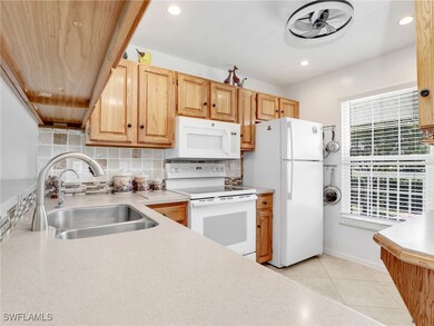 Kitchen with white appliances, a healthy amount of