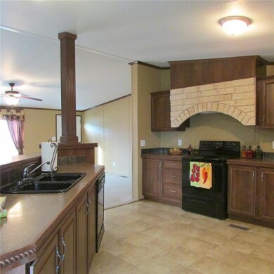 Kitchen Opens to Living Room and Dining Area