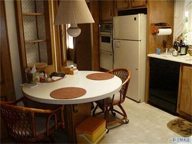 Oversized kitchen has extra entry way and all the 