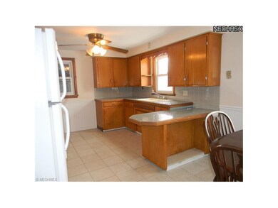 Kitchen features ceramic tile floor and countertop