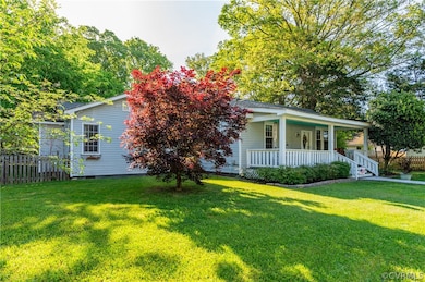 View of front of property with covered porch and a front lawn