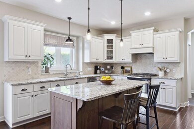Gourmet kitchen with granite, white, and stylish backsplash.