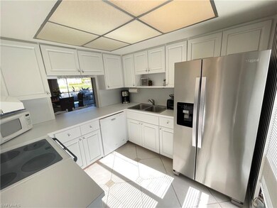 Kitchen featuring light tile patterned floors, whi