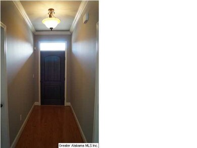 Foyer with hardwood floors and transom window over