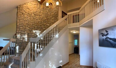 welcoming 2 story foyer with stunning stone accent