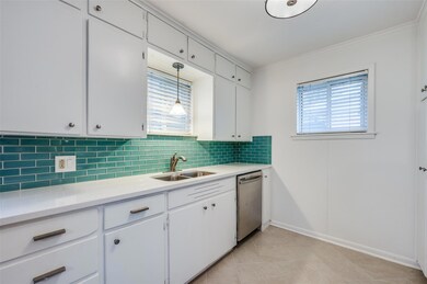 Kitchen featuring white cabinetry, decorative ligh