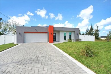 View of front of home with a front lawn and a gara