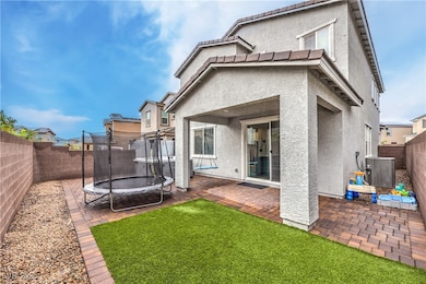 Rear view of property with a trampoline, stucco si