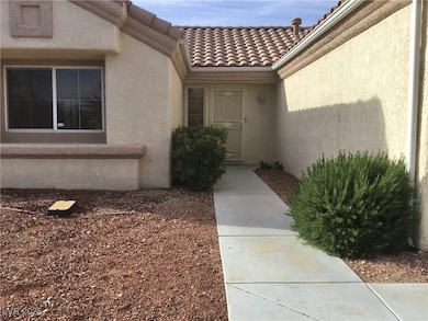 Doorway to property with stucco siding and a tile
