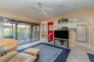 Tiled living room looking towards the kitchen and dining room