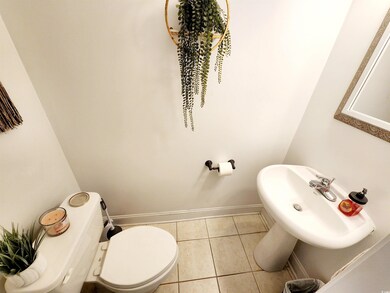 Bathroom featuring sink, tile patterned floors, an