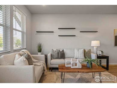 Welcoming front living room with three big windows providing ample natural light.