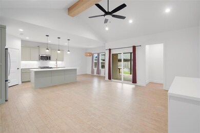 Beamed ceiling, pendant lighting, and ceiling fan