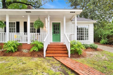Doorway to property with a chimney and covered porch