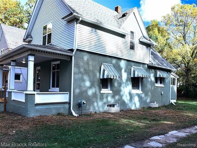 View of home's exterior with covered porch, a chimney, and shingled roof