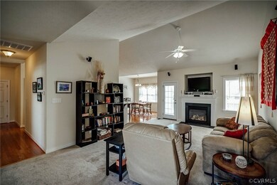 Family room with view of breakfast nook. Vaulted c