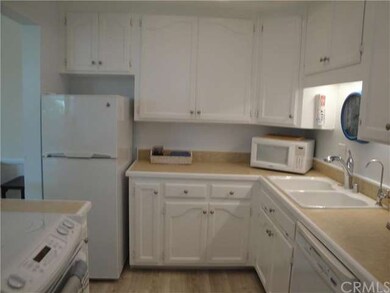 Kitchen with laminate wood flooring, ample storage