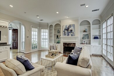 LIVING ROOM: 30 x 20 This light filled room has beautiful built-ins, a gas or wood burning fireplace and dry bar.