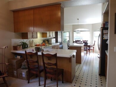 LOOKING INTO KITCHEN WITH CENTER ISLAND, AND DININ