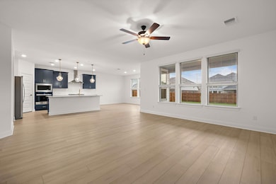 Unfurnished living room with ceiling fan, recesse